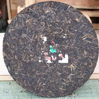 1999 China Tea Provincial Company Dry Storage Iron Discus Raw Pu-erh Tea Cake, 357g